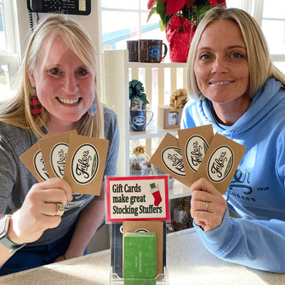 Two Woman happily showing their gift cards